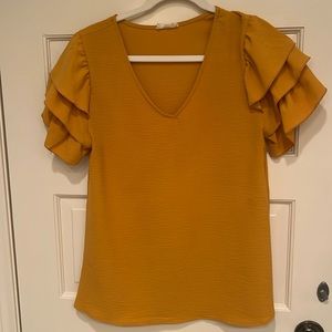 Mustard yellow polyester short sleeve top with ruffle sleeves